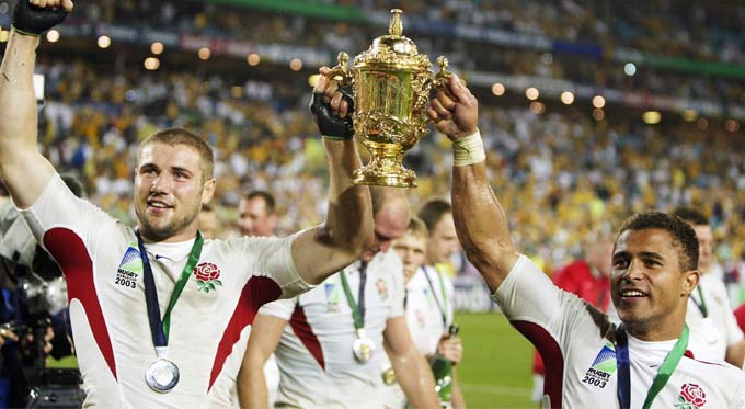 Team mates holding World Cup trophy